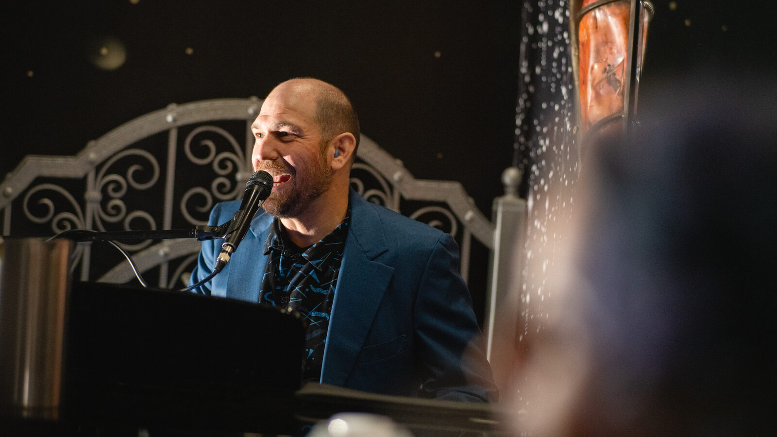Performer singing into the mic mid-song